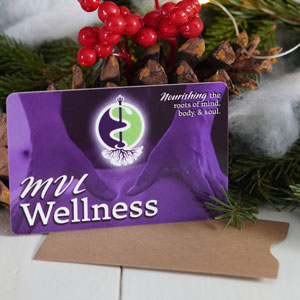 An image of a gift card against seasonal decorations. The card says MVL Wellness.